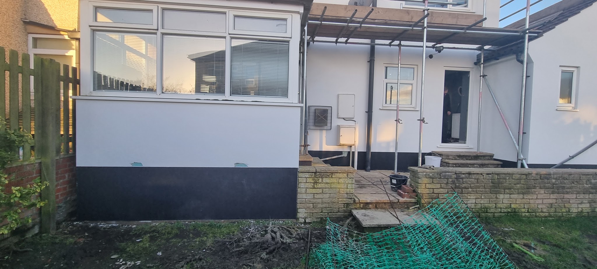New rendering around a bay window and entrance while scaffolding remains in place
